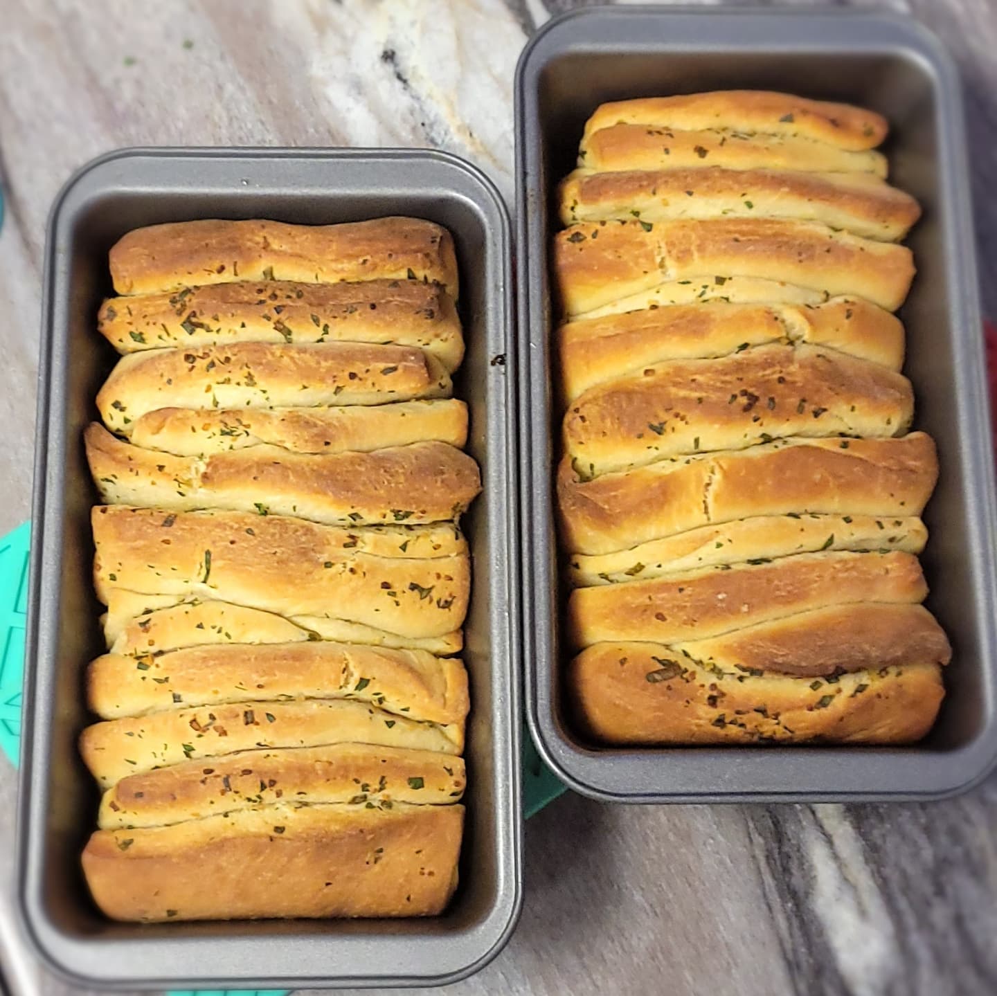 a picture of two pans of breadsticks